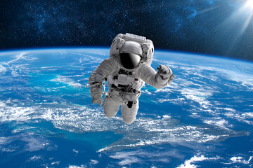 Astronaut in outer open space over the planet Earth.Stars provide the background.erforming a space above planet Earth.Sunrise,sunset.Our home. ISS.Elements of this Image Furnished by NASA.