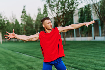 athletic man in red tank top posing outdoors fitness © VICHIZH