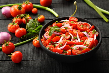 Bowl of healthy and delicious organic tomato , onions salad. 