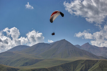 Paragliding with a pair of instructors.  Mountains landscape panorama