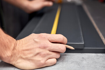Handyman making kitchen wall cabinets in the apartment.