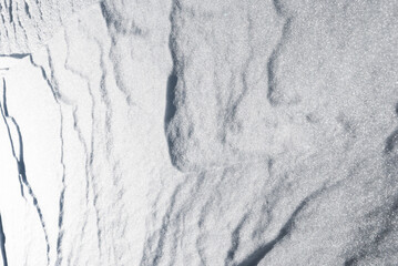 Solid, hard snow texture from a glacier. Abstract art of nature.