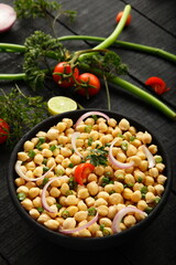 Bowl of delicious homemade chickpea salad with herbs.