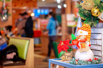 Christmas decorations in the interior. Festive background. New Year's room design, beautiful and shiny toys on the Christmas tree. Blurred background with copy space for text.