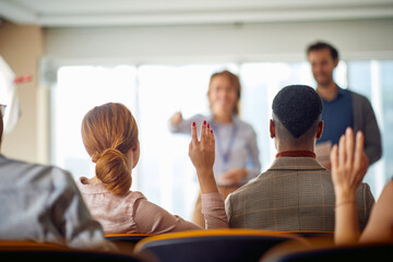 Young participants having discussion at a business lecture in the conference room. Business,...