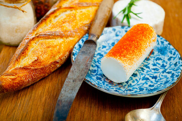 French cheese and fresh  baguette on a wood cutter