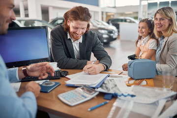 Cheerful caucasian family buying a car together