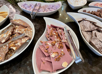 Assorted handmade Swiss chocolate and pralines on black table. 