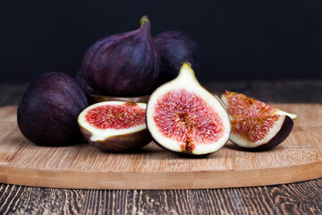 ripe purple figs on a wooden table