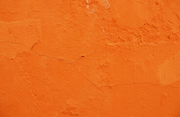 Abstract background of orange plaster on an old wall.