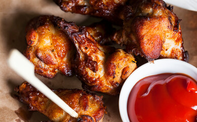 baked chicken wings together with ketchup