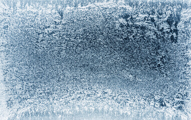 Naklejka na ściany i meble Frost patterns on frozen winter window as a symbol of Christmas wonder. Christmas or New year background.