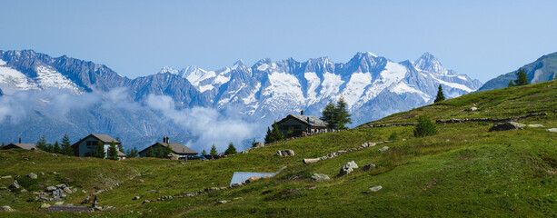 The mountain pastures and small villages among the meadows of the Simplon Pass (Switzerland), during a beautiful summer day - July 2021.