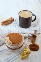 Apple and Cinnamon Cream Cup Dessert with a Cup of Cappuccino on light background