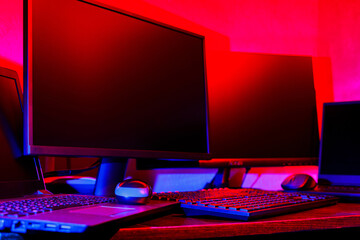 Creator's workplace in colored neon light. Computer equipment for creating visual content....