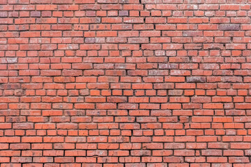 Obraz premium Old reddish brown worn weathered brick wall stone texture background