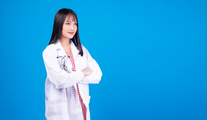 Health care occupation concept. Positive proud smile friendly doctor or nurse young woman wear uniform coat arms crossed with stethoscope while standing over isolated blue background with copy space.