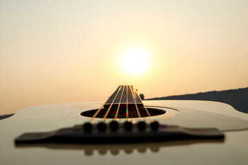 acoustic guitar at sunset