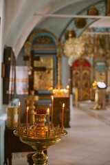 burning candles in church. Christianity religious background. Orthodox christian church interior.