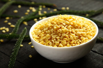 Traditional Indian vegetarian snack foods-  salted and baked moong dal. spiced  lentils. 