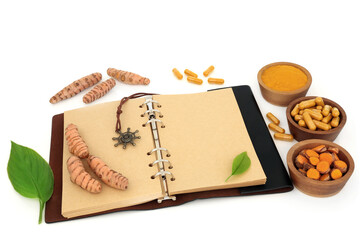 Turmeric root herb preparation with powder, dietary supplement capsules and old notebook. Used in natural herbal plant medicine. Is anti inflammatory, an antioxidant.