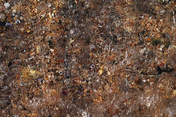 Sea stones, gravel under water. Colorful Stone Background. Textures. Abstract blurred water background.