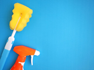Cleaning sponge and brush. Cleanliness concept. Clean house. Dry wet cleaning. Blue background, place for text. Cleaning.