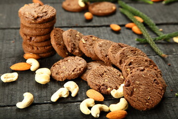 Homemade fresh baked cashew nuts, almonds cookies on a rustic kitchen table background. 