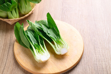Fresh Bok Choy or Pak Choi (Chinese cabbage) on cutting wooden board prepare for cooking