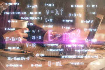 Double exposure of man's hands holding and using a phone and formulas drawing. Education concept.