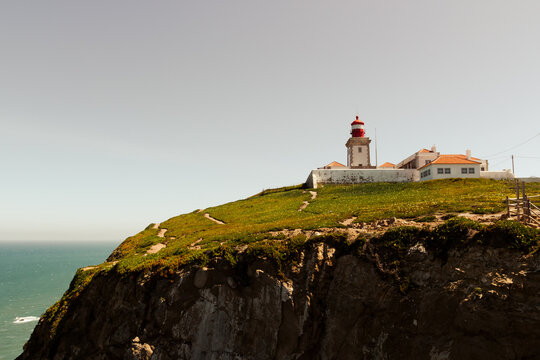 Cabo da roca lighthouse over the sea on a cliff  on a cloudy gloomy day