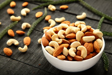 Bowl of roasted organic cashew nuts and almonds. healthy eating.