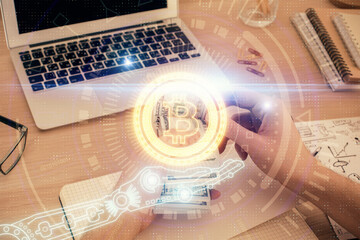 Multi exposure of blockchain theme drawing hologram and USA dollars bills and man hands. Business concept.