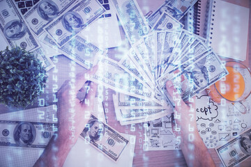 Multi exposure of technology drawing hologram and us dollars bills and man hands. Data concept