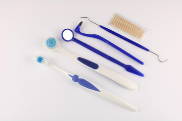  Toothbrush, tongue brush, mirror, pick, stain eraser and toothpicks isolated on a white background. Oral hygiene and DIY dentistry concept