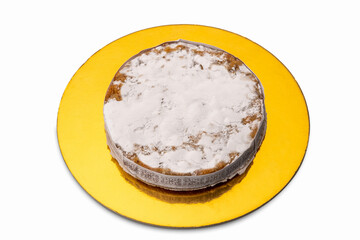 Panforte of Siena, traditional Christmas cake with almonds, orange peel and spices from tuscany, italy. On golden dish, isolated on white