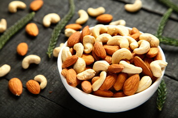 Bowl of roasted organic cashew nuts and almonds. healthy eating.