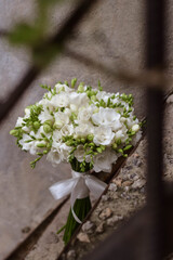 White freesia bridal bouquet on dark background. close up. Wedding bouquet.