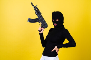 Young sexy beautiful woman with bright pink lips, balaclava on her head, holding a machine gun, bandit, thief, lawbreaker