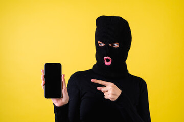 Woman with bright pink lips, balaclava on her head, holding a mobile phone, hacker, internet...