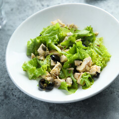 Healthy green salad with chicken and olives