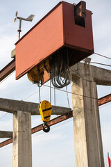 Industrial suspended winch on the sea pier.
