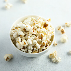 Homemade salted popcorn in a white bowl