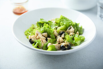 Healthy green salad with chicken and olives