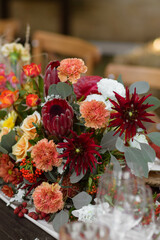 A very nicely decorated wedding table appointments with beautiful decor with plates and serviettes in spring garden. Beautiful flowers on table in wedding day. The elegant dinner table.