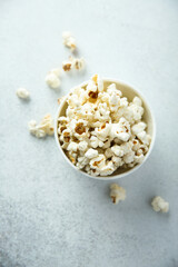 Homemade salted popcorn in a white bowl