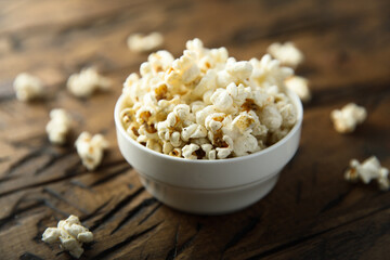 Homemade salted popcorn in a white bowl