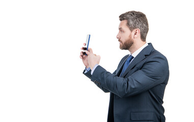 Businessman in business suit point finger at mobile phone isolated on white copy space, pointing