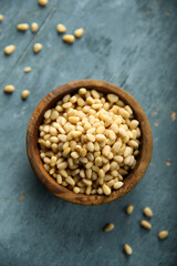 Organic pine nuts in a wooden bowl