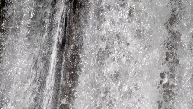Slow motion of water release flowing, water overflows, excess capacity of the dam , closeup